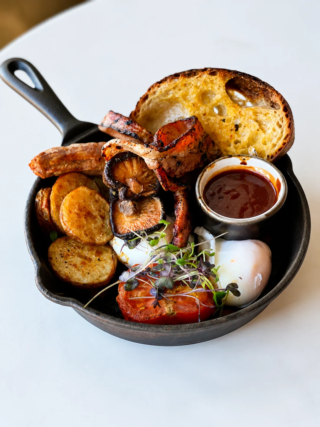 Breakfast plate with toast, mushrooms, potatoes and eggs at Eddie's