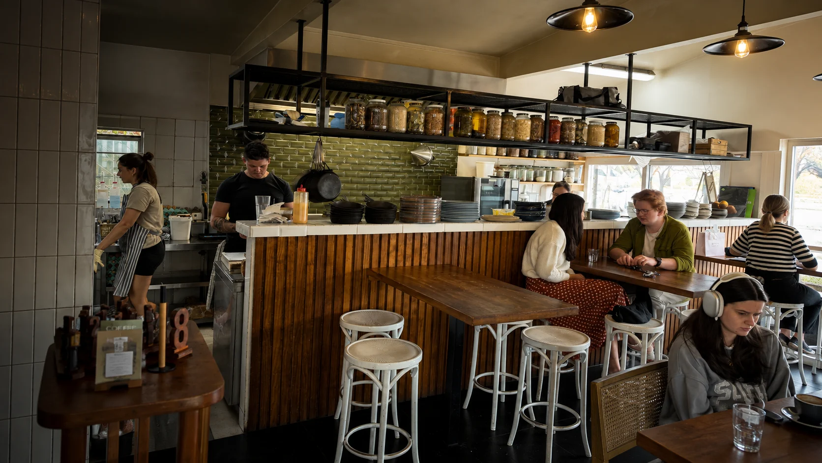 Inside Eddie's Brunch Parlour with the kitchen, counter and guests